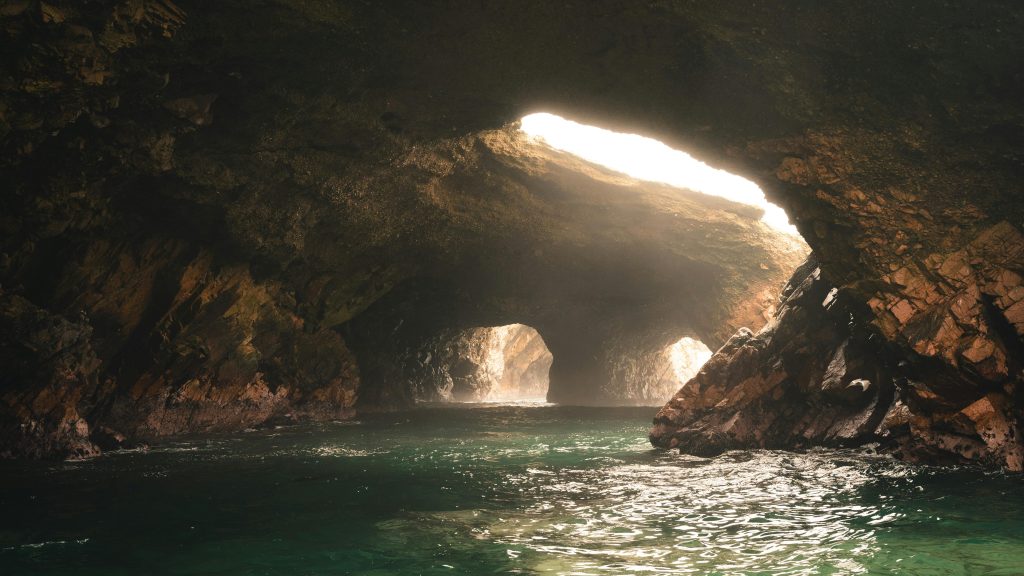 Sunlight streams into a serene cave on the Ballestas Islands in Peru.